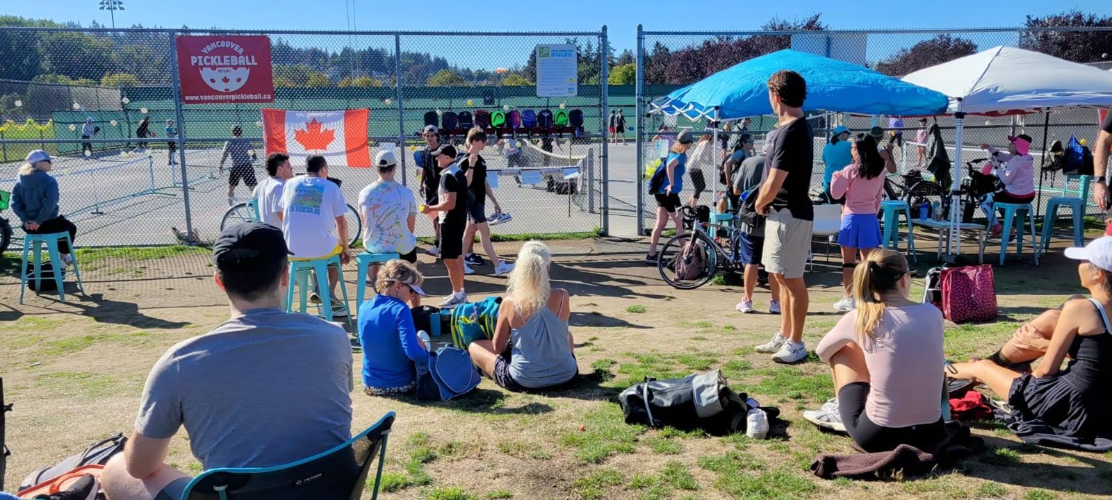 Players and spectators enjoying a busy day at the Jericho pickleball courts